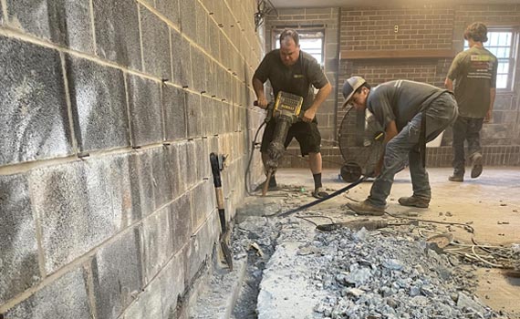 a broken drain tile is being repaired