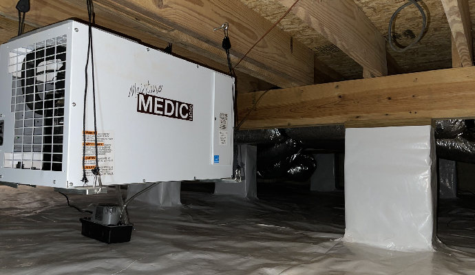Dehumidification system installed in the crawl space