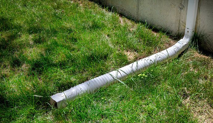Downspout extension installed on the side of a building