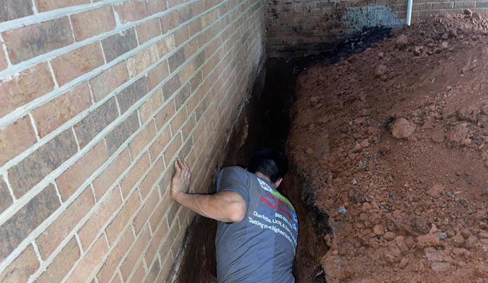 Person repairing drainage system